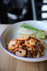 Pad thai with shrimp . Thai food on wood background