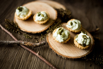 Wooden plates with small salty tart