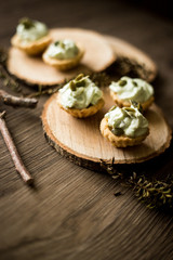 Wooden background and creamcheese tarts