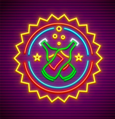 Neon sign for bar with bottles beer, nighttime illumination.