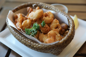 Calamari rings , fried squid on wood background , Italian food