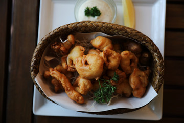 Calamari rings , fried squid on wood background , Italian food