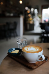 Cappuccino coffee cup on wood background