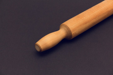 Rolling pin  on a dark background. 