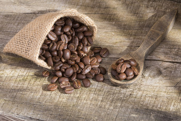 Roasted coffee on the wooden background - Coffee