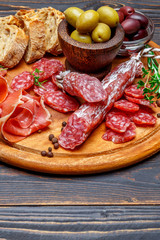Dried organic salami sausage or spanish chorizo on wooden cutting board