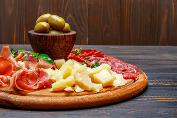 Meat and cheese plate with salami sausage, chorizo, parma and parmesan cheese