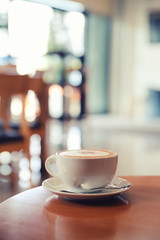 cappuccino or Latte art coffee made from milk on the wood table in coffee shop