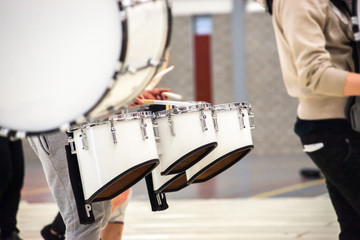 Drummer Playing Tenor Drums in a drum band during a show performance.