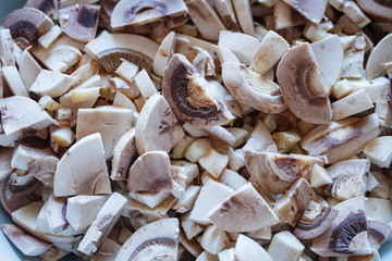 Champignon mushrooms, sacking mat and spices on wooden background