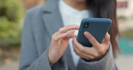 Business woman look at mobile phone