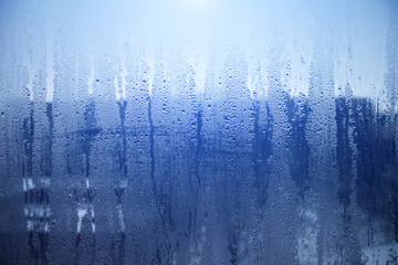 Rain drops on window glasses surface with sky cloudy background or texture grey frames abstract water of rainy day on black and white city at night silhouette Natural Pattern
