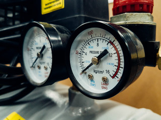 Air compressor system: manometer, cable, gun and accessories, closeup.