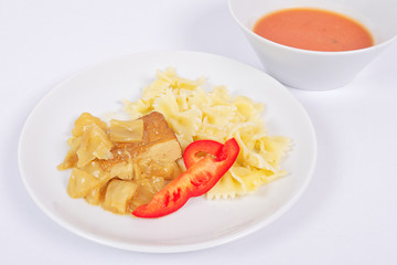 Tofu with vegetables and pasta on a white