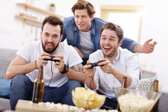 Friends having fun on the couch with video games