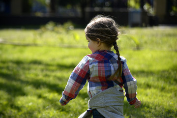 Fototapeta premium little girl running in the Park