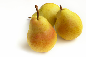 Three ripe pears on a white background