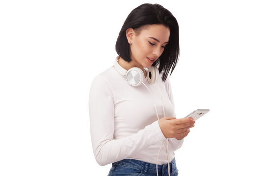Young beautiful woman with cellphone and headphones