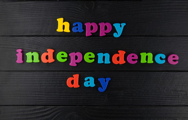 Happy Independence day, colorful letters on black.