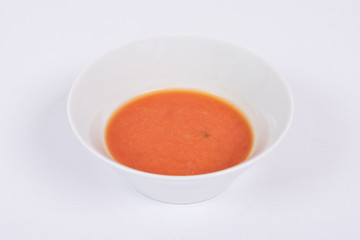 Tomato soup with milk on a white