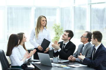 business team applauding the speaker at the meeting.