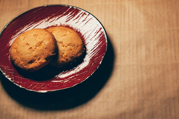 round crunchy sweet cookies on a red saucer