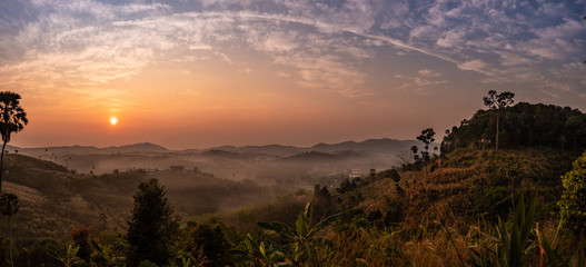 Landscape view of sunrise, mountains and foggy
