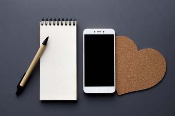 blank notepad with smartphone and pen