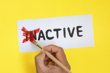 inactive is active concept. Hand with brush and card with word inactive