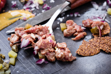 Steak tartare preparation.  Raw ground beef dish