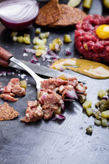 Steak tartare preparation.  Raw ground beef dish