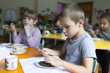 Children eat in kindergarten