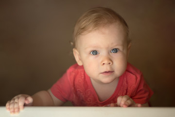 portrait of a little girl with two teeth with natural light looking up.