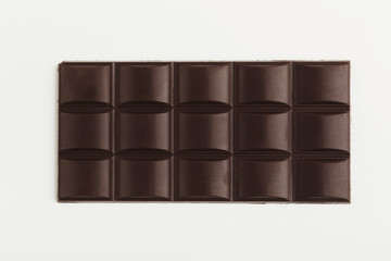 Bar of dark chocolate isolated on white