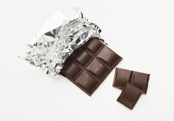 Bar of dark chocolate isolated on white