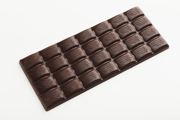 Bar of dark chocolate isolated on white