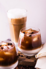 Iced coffee in glasses with milk. Black background