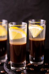 Alcoholic cocktail silver bullet with gin, coffee liqueur and lemon.