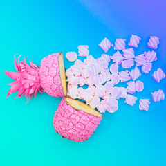 two painted in pink color halfs of the pineapple of which fall marshmallow with holographic gradient blue and green colors. fashion minimalism concept of summer food. surreal
