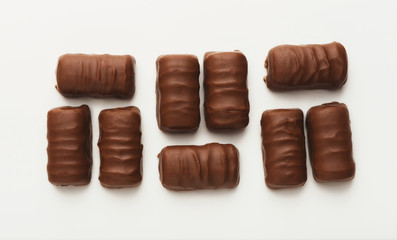 Small chocolate candies isolated on white