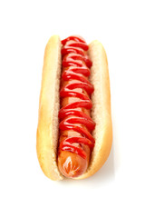 Hot dog with grilled sausage and ketchup on white