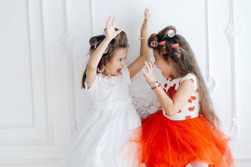 Fototapeta na wymiar Cheerful artistic girls in beautiful dresses