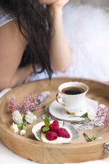 White and pink flowers. Breakfast in bed.Happy woman. Flavored coffee. Delicate light colors. Romance. Place for text