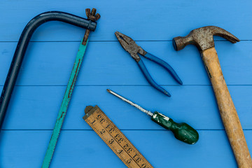 Old hammer and DIY tools on wood background