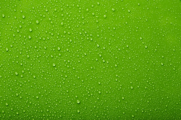 Small and large drops of water on a colored background. Abstract liquid sprays