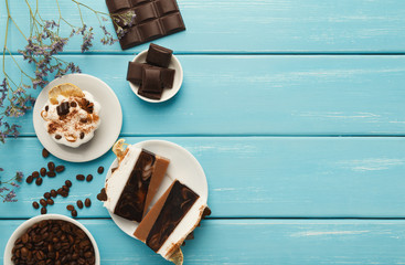 Various desserts: cakes and chocolate bars on turquoise rustic t