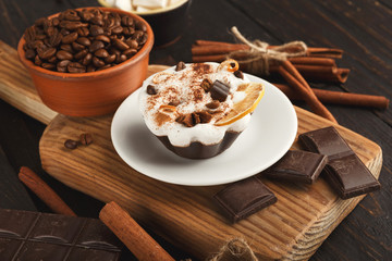 Various sweet treats: cakes and chocolate bars on dark rustic ta
