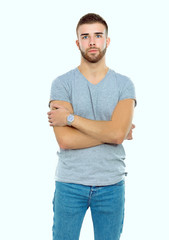 Portrait of a happy casual man standing isolated on a dark background