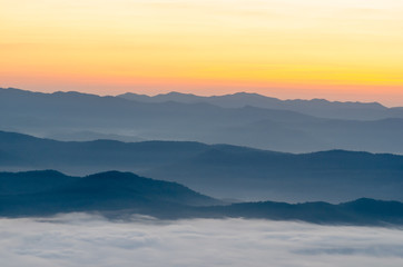 Fototapeta na wymiar Sunset over mountains and fog