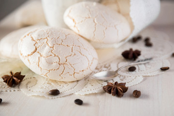 Beige beze with coffee, anise, coffee beans and silver spoon